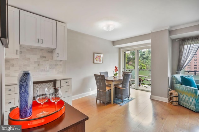 4201 Cathedral Ave NW Unit 616W, Washington, DC 20016 - dining space with baseboards, light wood-style floors, and crown molding