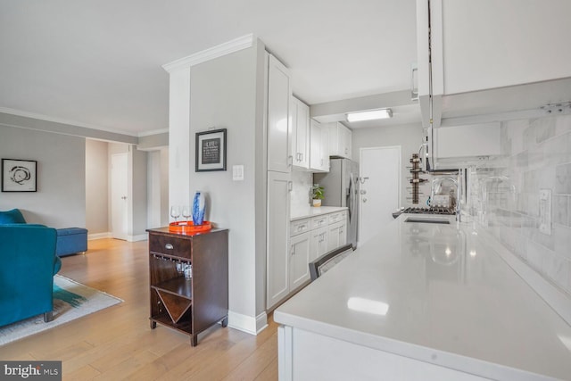 4201 Cathedral Ave NW Unit 616W, Washington, DC 20016 - kitchen featuring white cabinets, light countertops, and light wood-style flooring