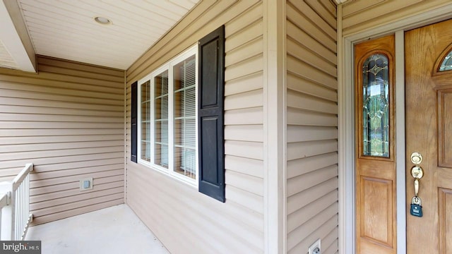 view of exterior entry with covered porch