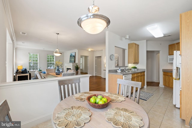 6704 Holly Farm Ln Unit 203, New Baltimore, VA 20187 - dining space featuring a fireplace and light tile patterned floors