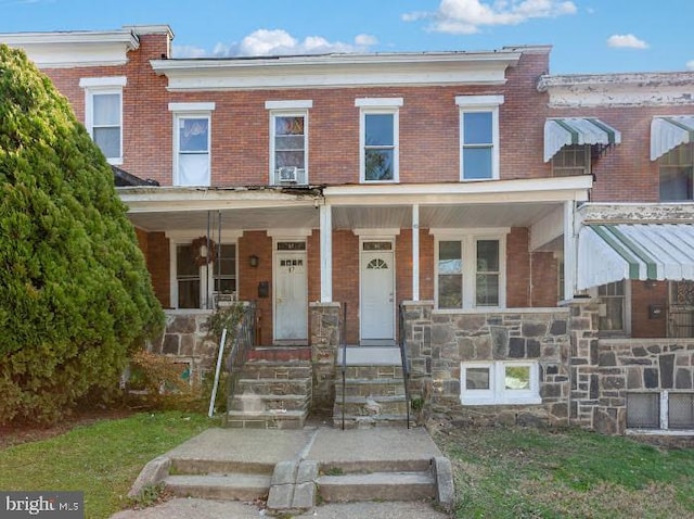 65 N Monastery Ave, Baltimore, MD 21229 - view of property featuring brick siding and covered porch