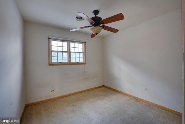 spare room with baseboards, carpet flooring, and a ceiling fan