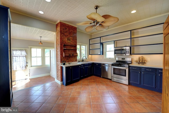 kitchen featuring appliances with stainless steel finishes, blue cabinetry, crown molding, light countertops, and light tile patterned flooring