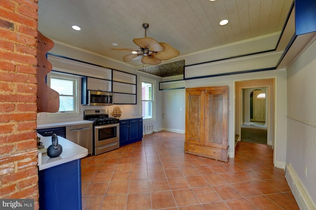kitchen with stainless steel appliances, blue cabinetry, ceiling fan, light countertops, and light tile patterned floors