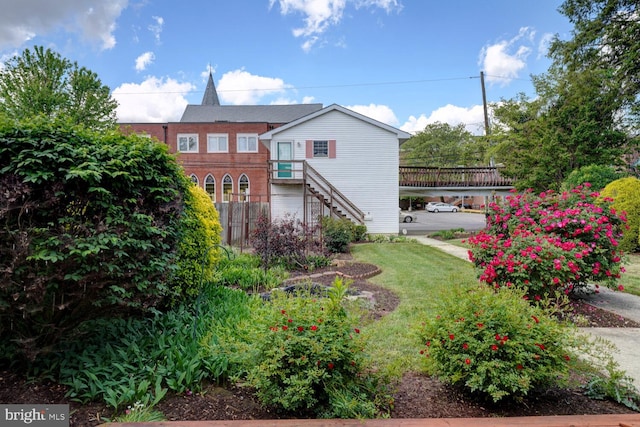 view of green lawn with stairway