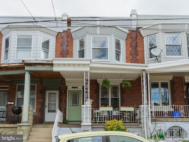 view of front of property with a porch and brick siding
