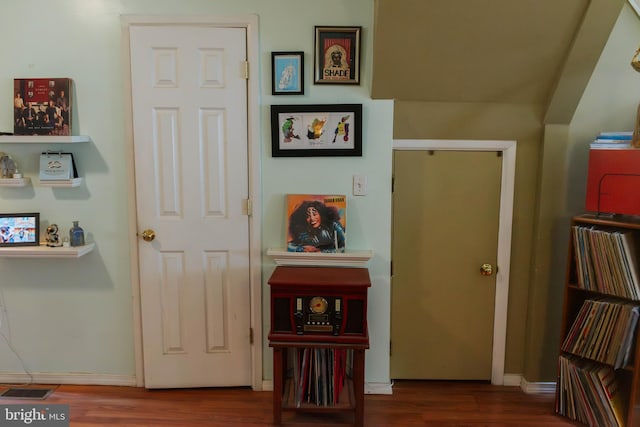 interior space with baseboards, visible vents, and wood finished floors