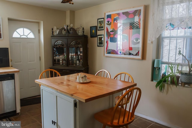 dining area with dark tile patterned floors
