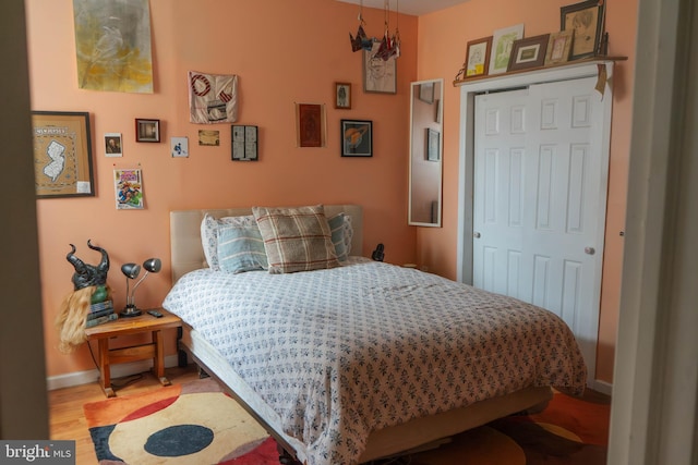 bedroom featuring baseboards and wood finished floors