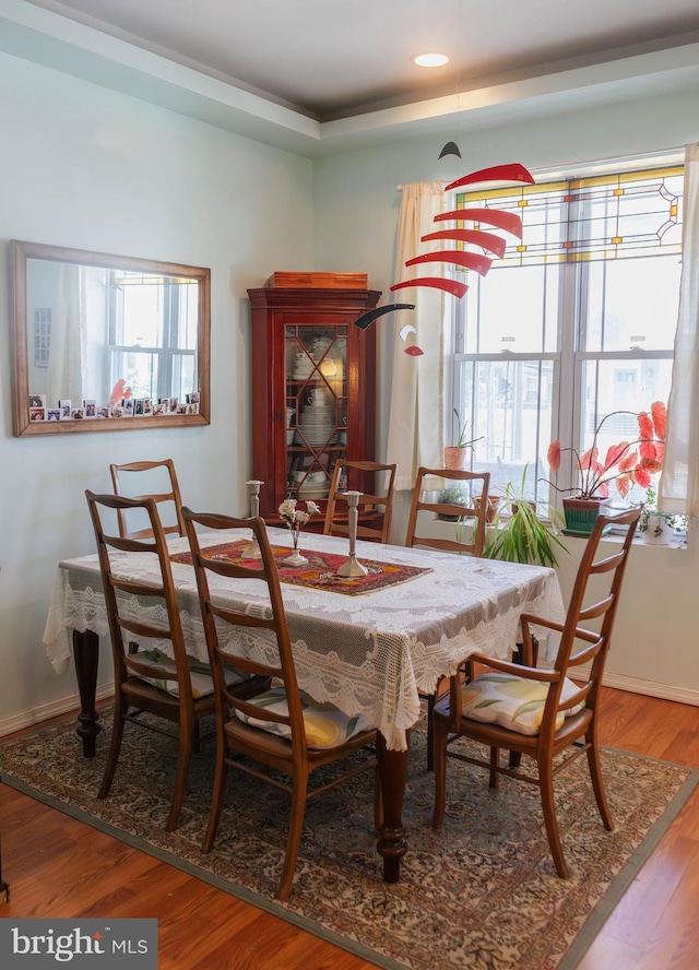 dining space featuring baseboards, recessed lighting, and wood finished floors