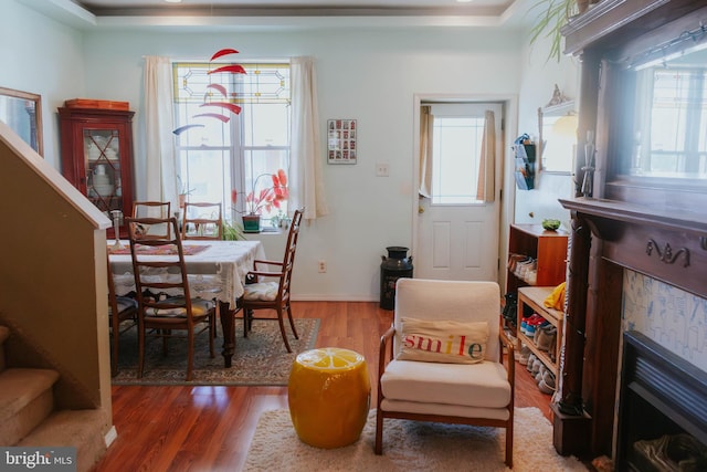 living area featuring stairs, plenty of natural light, and wood finished floors