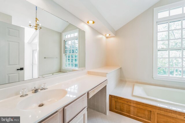 full bath with plenty of natural light, a bath, lofted ceiling, and vanity
