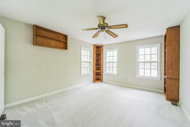 spare room featuring ceiling fan, baseboards, and carpet