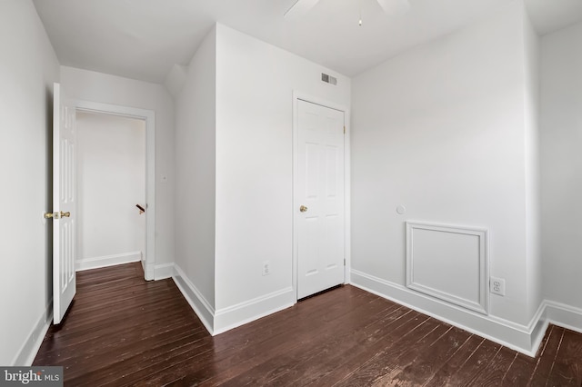 unfurnished bedroom with visible vents, a ceiling fan, baseboards, and hardwood / wood-style floors