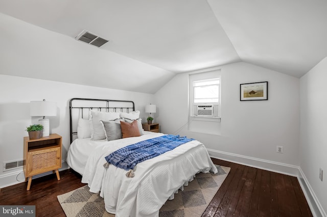 bedroom featuring visible vents, baseboards, wood-type flooring, and lofted ceiling