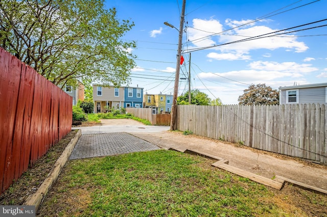 view of yard featuring a patio, fence private yard, and driveway