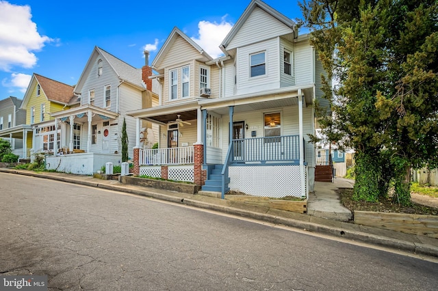 townhome / multi-family property featuring covered porch and cooling unit