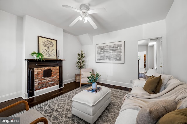 living area featuring vaulted ceiling, baseboards, a ceiling fan, and wood finished floors