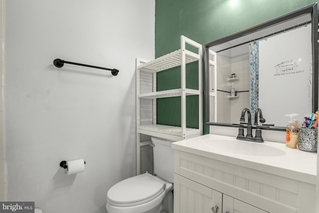 bathroom featuring vanity, a shower with curtain, and toilet