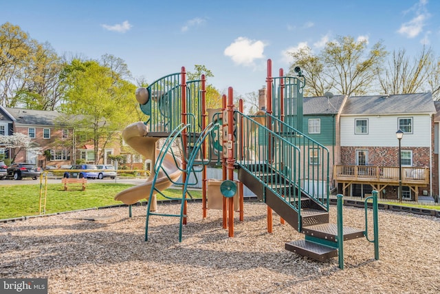 community jungle gym featuring a lawn