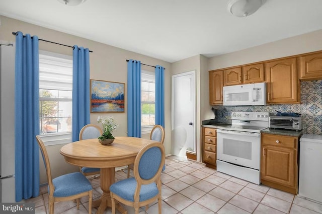 12714 Harborview Ct, Woodbridge, VA 22192 - kitchen with brown cabinets, decorative backsplash, white appliances, and light tile patterned flooring