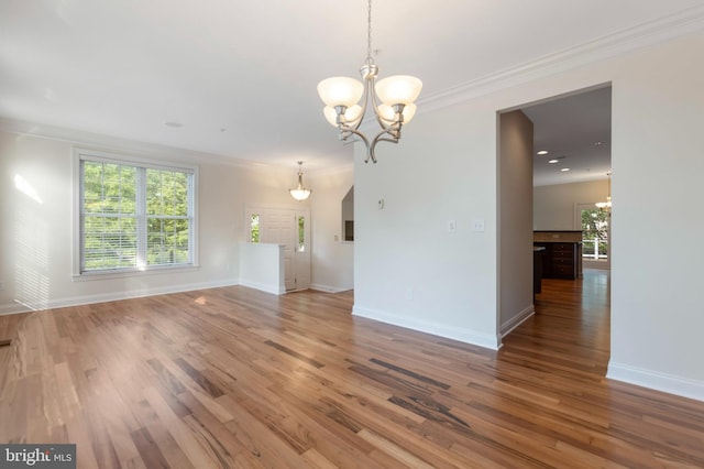 4102 Chariot Way, Upper Marlboro, MD 20772 - unfurnished living room featuring a chandelier, wood finished floors, baseboards, healthy amount of natural light, and ornamental molding