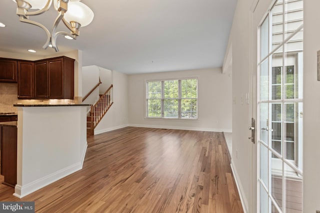 4102 Chariot Way, Upper Marlboro, MD 20772 - unfurnished living room with light wood finished floors, a chandelier, baseboards, stairs, and recessed lighting