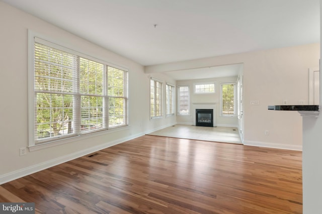 4102 Chariot Way, Upper Marlboro, MD 20772 - unfurnished living room with a glass covered fireplace, wood finished floors, and baseboards