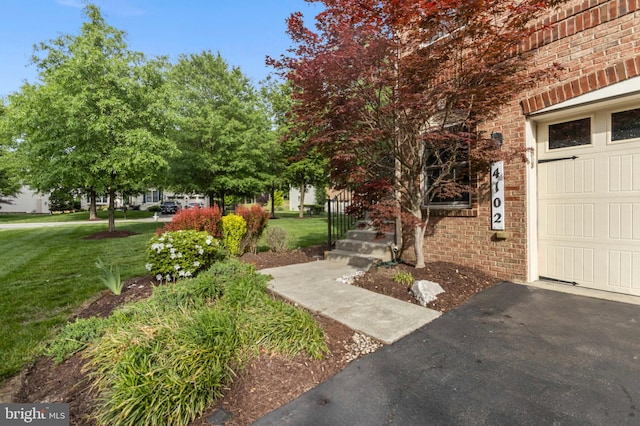 4102 Chariot Way, Upper Marlboro, MD 20772 - doorway to property with brick siding, a lawn, and driveway