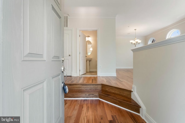 4102 Chariot Way, Upper Marlboro, MD 20772 - corridor with light wood-type flooring, a chandelier, ornamental molding, baseboards, and a sink