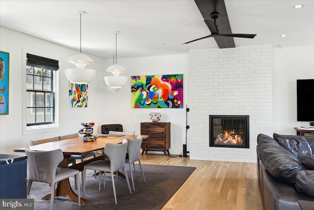 dining space with a fireplace, recessed lighting, ceiling fan, and light wood-type flooring