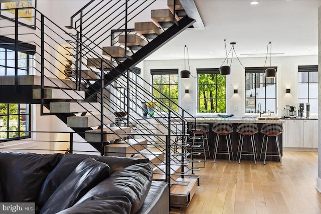 stairs with wood-type flooring and recessed lighting