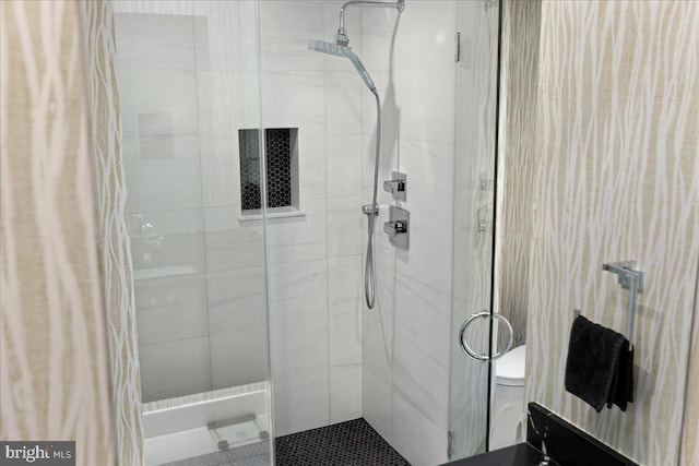 full bathroom with a stall shower and toilet