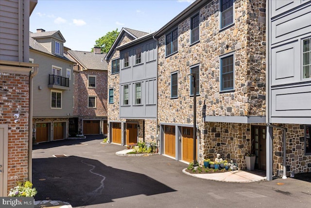 view of property featuring a garage and driveway