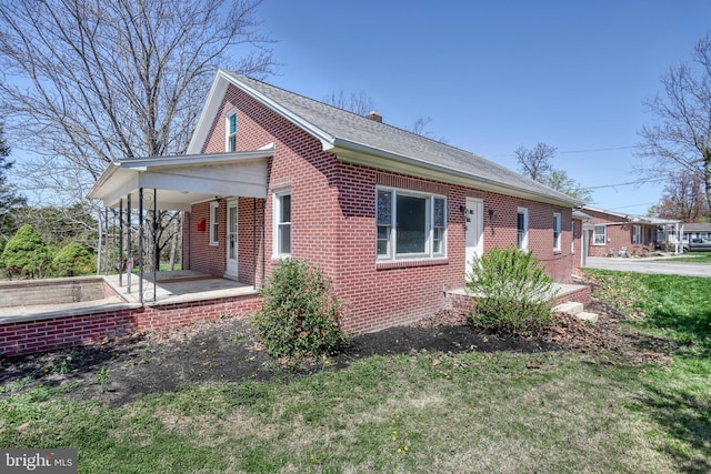 35 Herrs Ridge Rd, Gettysburg, PA 17325 - view of side of home featuring covered porch, brick siding, and roof with shingles