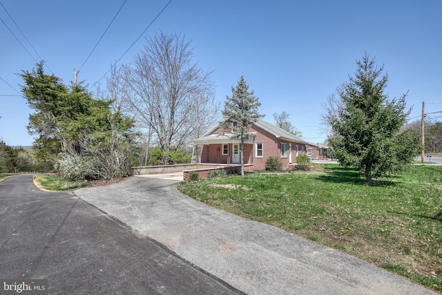 35 Herrs Ridge Rd, Gettysburg, PA 17325 - view of front of house featuring a porch, driveway, a front lawn, and brick siding
