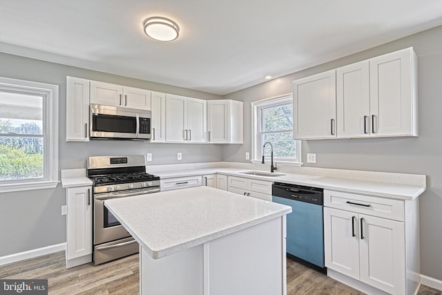 35 Herrs Ridge Rd, Gettysburg, PA 17325 - kitchen with light wood-style floors, a center island, white cabinets, a sink, and appliances with stainless steel finishes