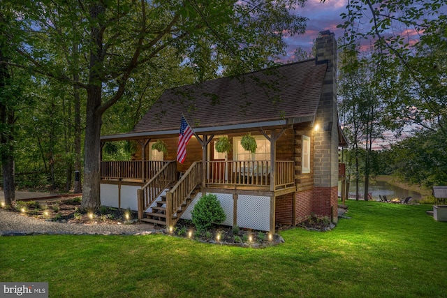 2 Heights Ct, Ruther Glen, VA 22546 - view of front of property featuring a porch, a front lawn, stairs, a chimney, and a water view