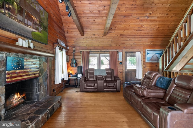 2 Heights Ct, Ruther Glen, VA 22546 - living area featuring wood walls, hardwood / wood-style flooring, beamed ceiling, wood ceiling, and a fireplace