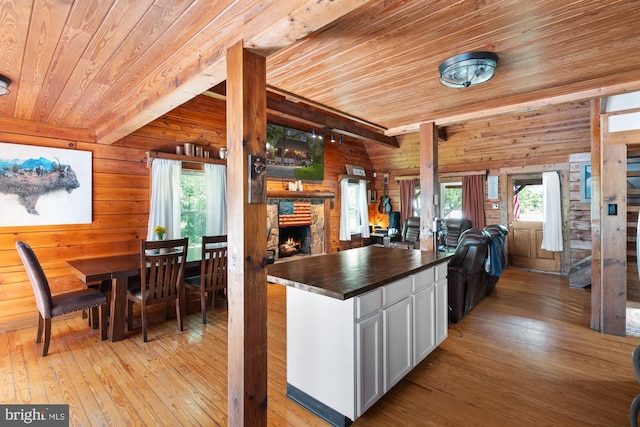 2 Heights Ct, Ruther Glen, VA 22546 - kitchen with wood ceiling, light wood-type flooring, open floor plan, a stone fireplace, and wood walls