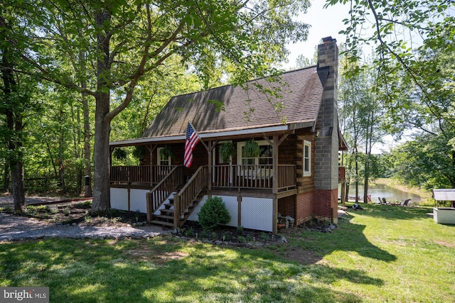 2 Heights Ct, Ruther Glen, VA 22546 - log-style house featuring a front yard, covered porch, stairway, a water view, and a chimney