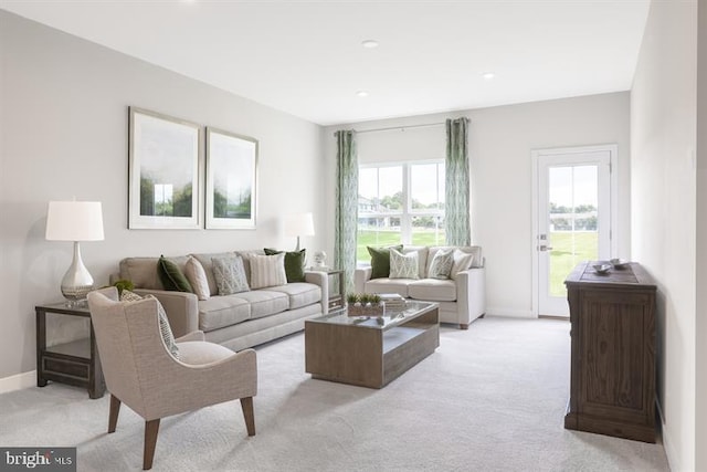 living room with recessed lighting, baseboards, and light colored carpet