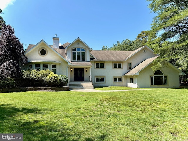 162 Tuckerton Rd, Medford, NJ 08055 - view of front of property with a front yard, stucco siding, a chimney, and a shingled roof