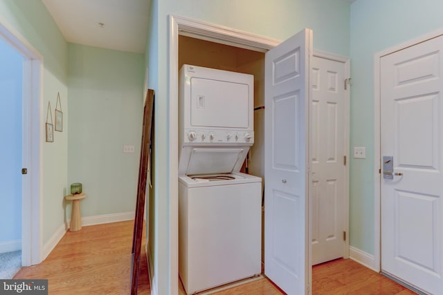 300 W Elm St Unit 2206, Conshohocken, PA 19428 - laundry area with stacked washer / dryer, light wood-style flooring, and baseboards