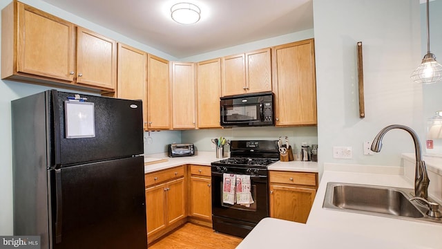 300 W Elm St Unit 2206, Conshohocken, PA 19428 - kitchen with black appliances, a sink, light countertops, light wood finished floors, and light brown cabinets