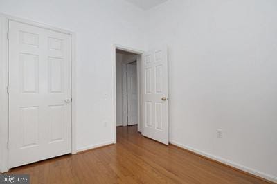 unfurnished bedroom with baseboards and wood finished floors