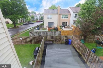 back of property with a chimney, a residential view, and a fenced backyard