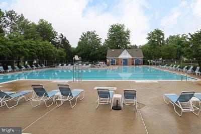 community pool featuring a patio and fence