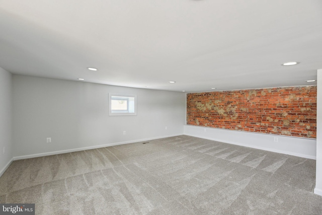 2817 Ulman Ave, Baltimore, MD 21215 - spare room featuring carpet flooring, baseboards, recessed lighting, and brick wall
