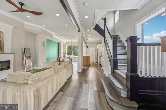 2817 Ulman Ave, Baltimore, MD 21215 - living area featuring crown molding, ceiling fan, dark wood-type flooring, recessed lighting, and a glass covered fireplace
